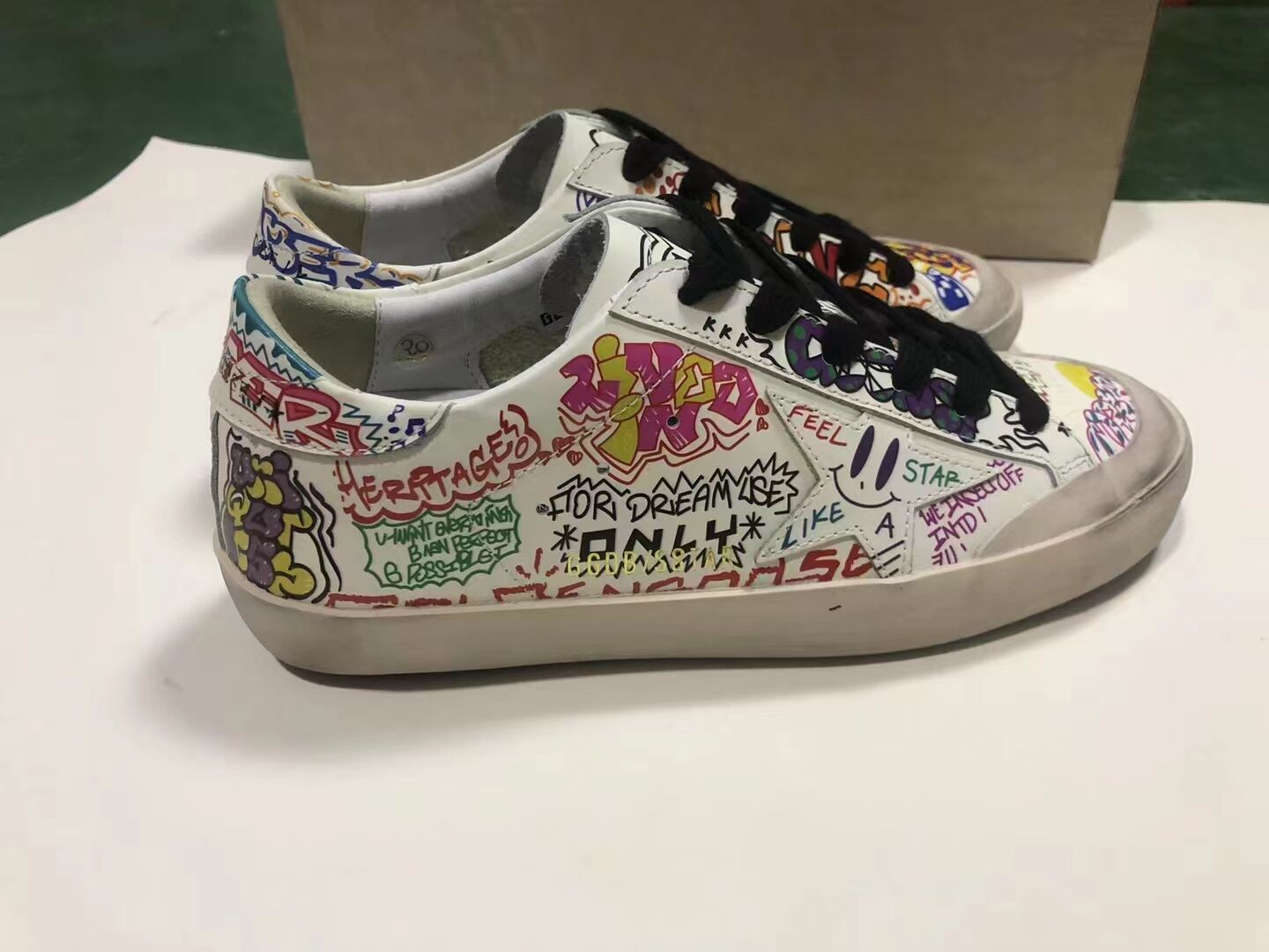 Super-Star sneakers in white leather with multicolored graffiti print